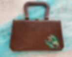 Thumbnail: Brown handbag with handle, floral design. Vintage accessory, sixteensisters.com.