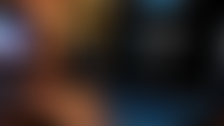 Laptop on desk with XSplit Broadcaster software open, warm bokeh lights in background, and TV showing a person. Cozy and focused ambiance.