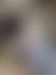 An employee stands beside large bags filled with charity donations