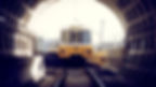 The image shows a yellow metro vehicle from 45 years ago passing through a the Tyne and Wear tunnel