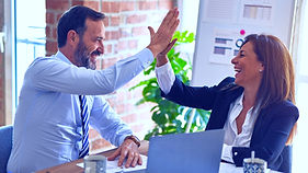 Two middle age business workers smiling