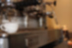 Espresso machine in the club facilities with a white cup.