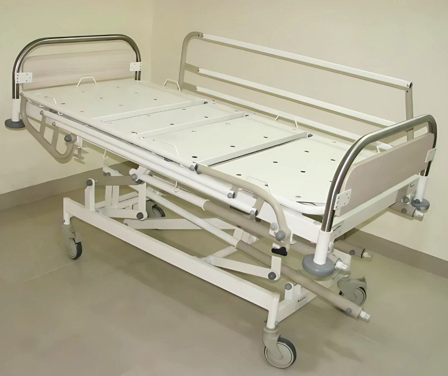 Low-height hospital bed with side rails in pediatric ICU setting