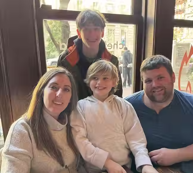 family of four spending time together in restaurant