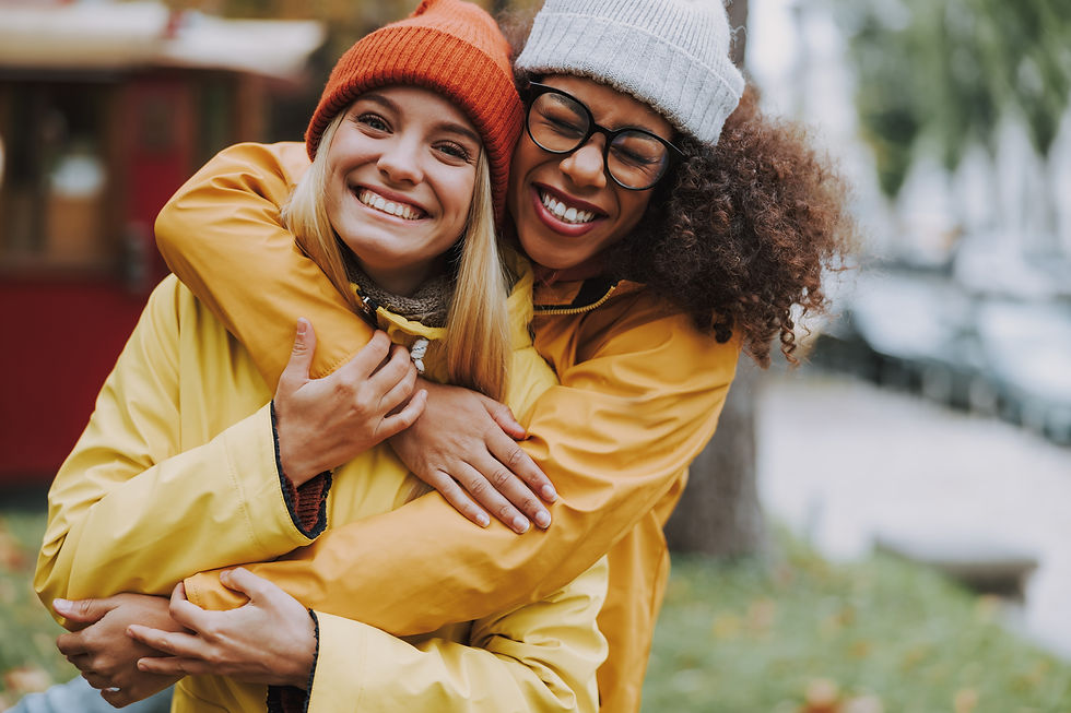 Two friends laughing together, illustrating how to be a better friend through support and joy.