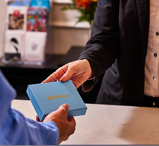 gift card box being handed to a customer