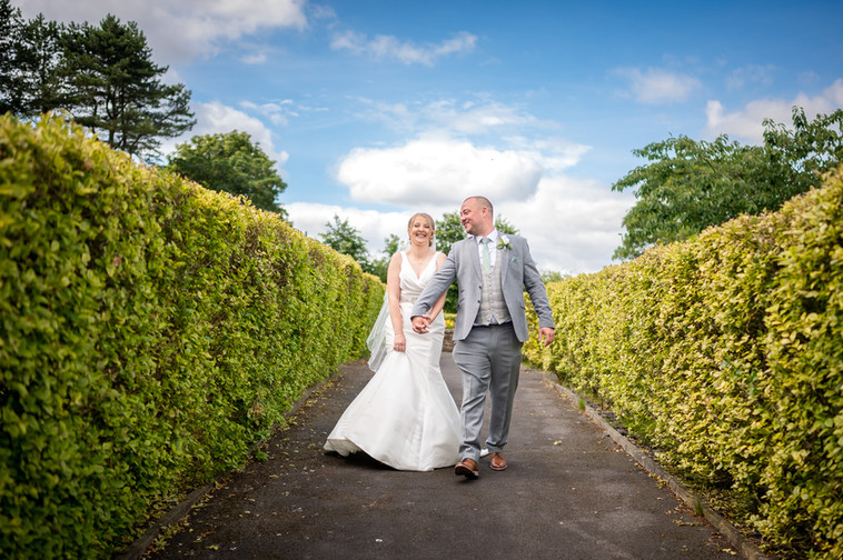 bride and groom-walking-holding hands,bolholt-stables-bury-wedding photography-lancashire