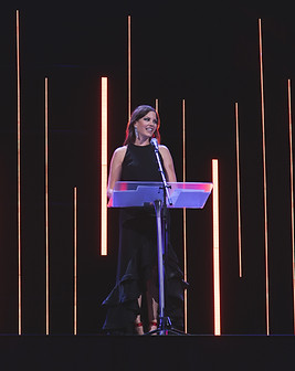 Sarah at a podium speaking