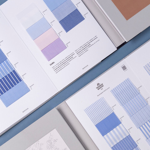 Thomas Mason shirting book pages showing curated blue, white and pastel cloth selections