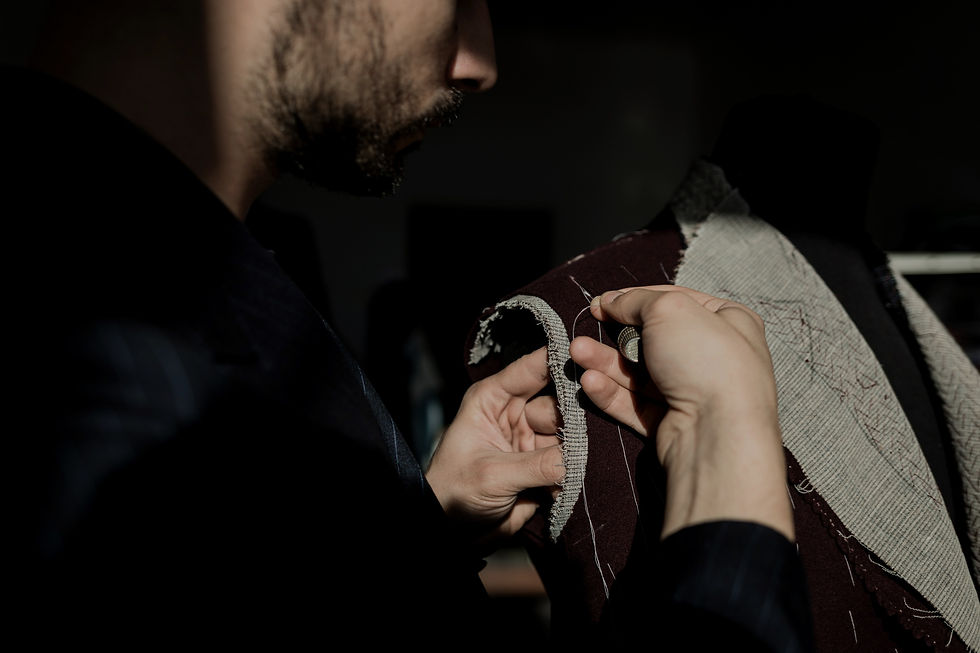 Tailor performing hand work on a custom suit