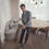 Thumbnail: Model wearing an outfit which includes wool denim pleated trousers