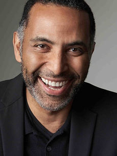 David - A headshot of a classic model with short dark hair, light stubble, and a bright smile, represented by Roc Talent Agency UK