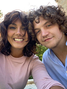 Meera and Matt - shot of a couple featuring a woman with short curly hair, and a wide smile, and a man with curly hair, and a natural expression, represented by ROC Talent Agency UK