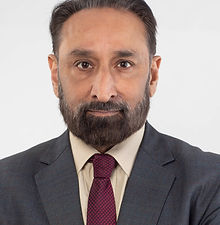 Rav - headshot of a male actor with swept back hair, a full beard, and wearing a shirt, jacket and tie, represented by ROC Talent Agency UK