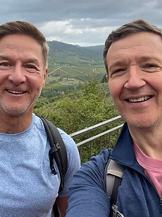 Bryan and Bill - headshot of a couple featuring a man with swept back hair, a natural smile, with man with short swept back hair and a wide smile, represented by ROC Talent Agency UK