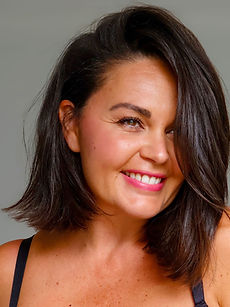 Jordana - headshot of a curve female model with shoulder-length dark hair, a warm smile, and a natural expression, represented by ROC Talent Agency UK