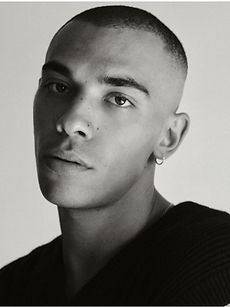 Jed - black and white headshot of male model with buzzcut, hoop earrings, and a dark top, represented by ROC Talent Agency UK