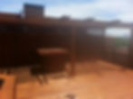 Custom standing table under pergola on rooftop deck