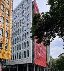 Multi coloured 11 storey office buildings designed by Renzo Piano.