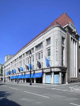 View of a building with a large retail store on the ground floor, located in View of a glass fronted office block on Tottenham Court Road, Fitzrovia, London, WC1  