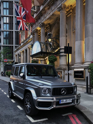 Entrance to hotel and luxury 4X4. 