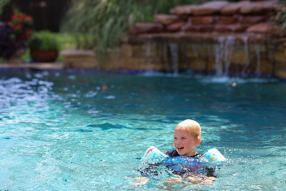 Family enjoying a custom pool in summer built by Signature Custom Pools in Oklahoma