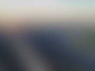 Ground-level shot looking down a tracker row at a utility-scale site, showing panel rows in tracking position with visible clearance between panels and groundcover