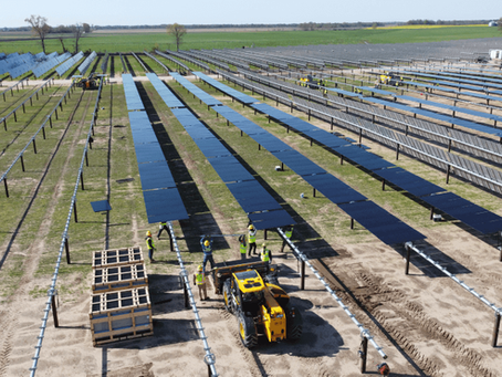 Heavy equipment performing civil grading and erosion repair at a utility-scale solar farm