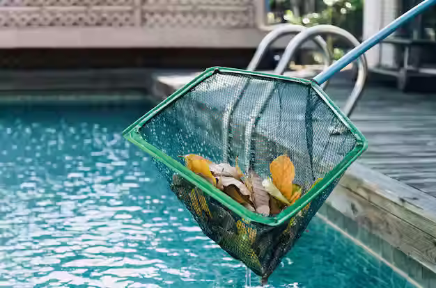 Skimming leaves from a pool during fall maintenance in Oklahoma