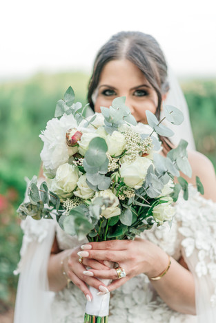 Outdoor garden wedding with bride with floral bouquet.