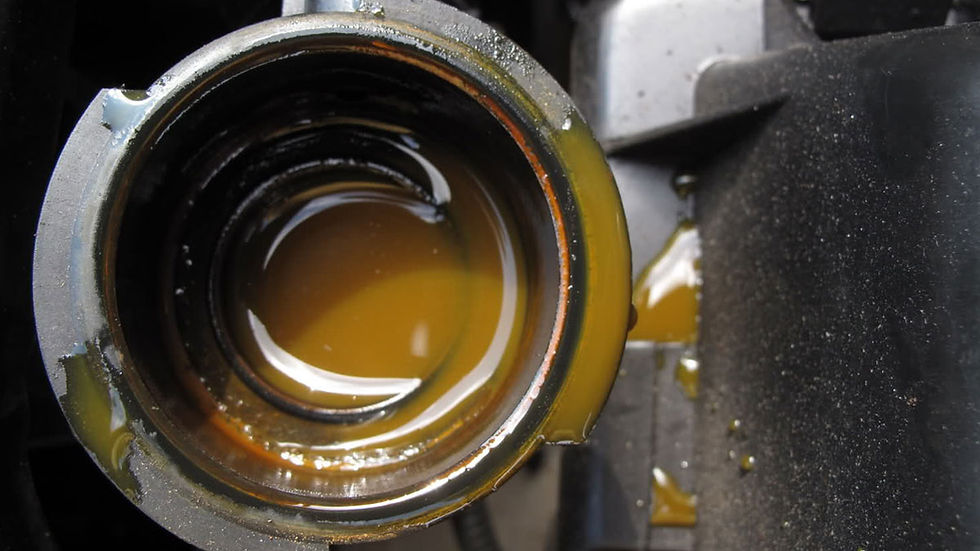 Close-up view of a car radiator cap with coolant visible inside