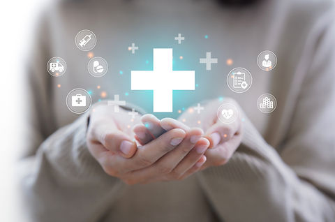 Woman's hands holding glowing medical cross, telehealth services
