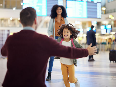 father greeting daughter at airport
