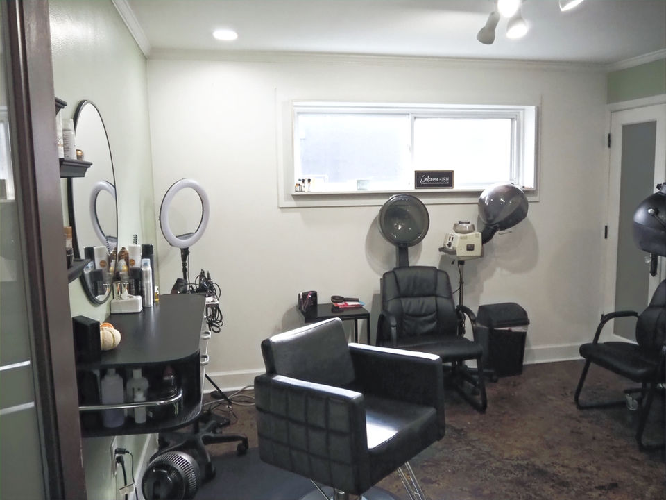 Salon interior with chairs, mirrors, and styling tools ready for clients.