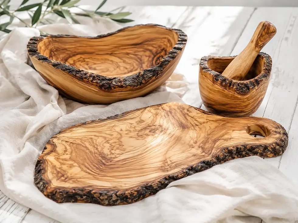 Handcrafted olive wood board, bowl, and mortar with rustic bark edges.