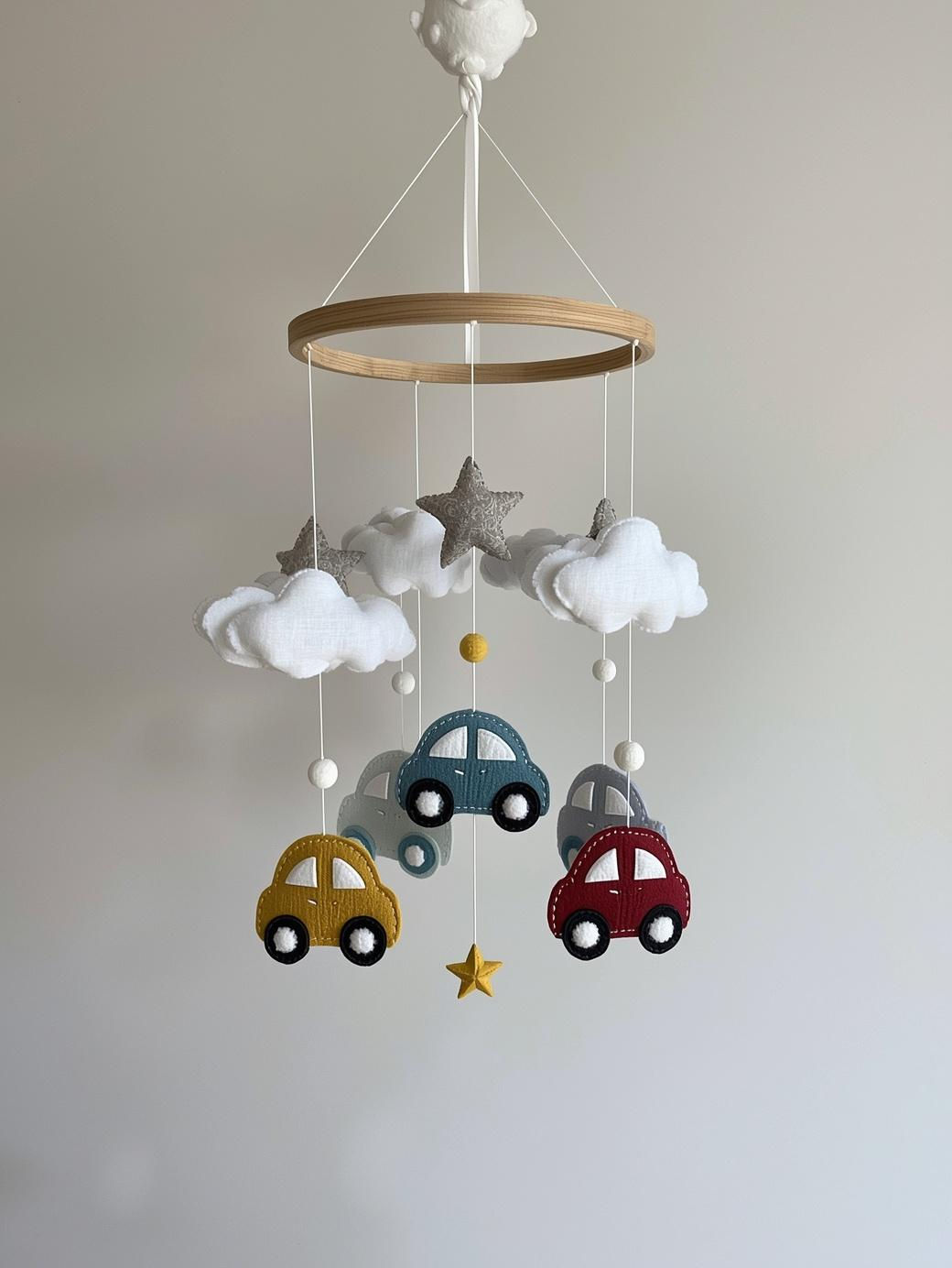 DIY car baby boy mobile craft kit featuring colourful fabric vehicles and white clouds for a transportation nursery theme