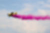 flying agricultural aircraft M-18 Dromader with colored smoke.jpg