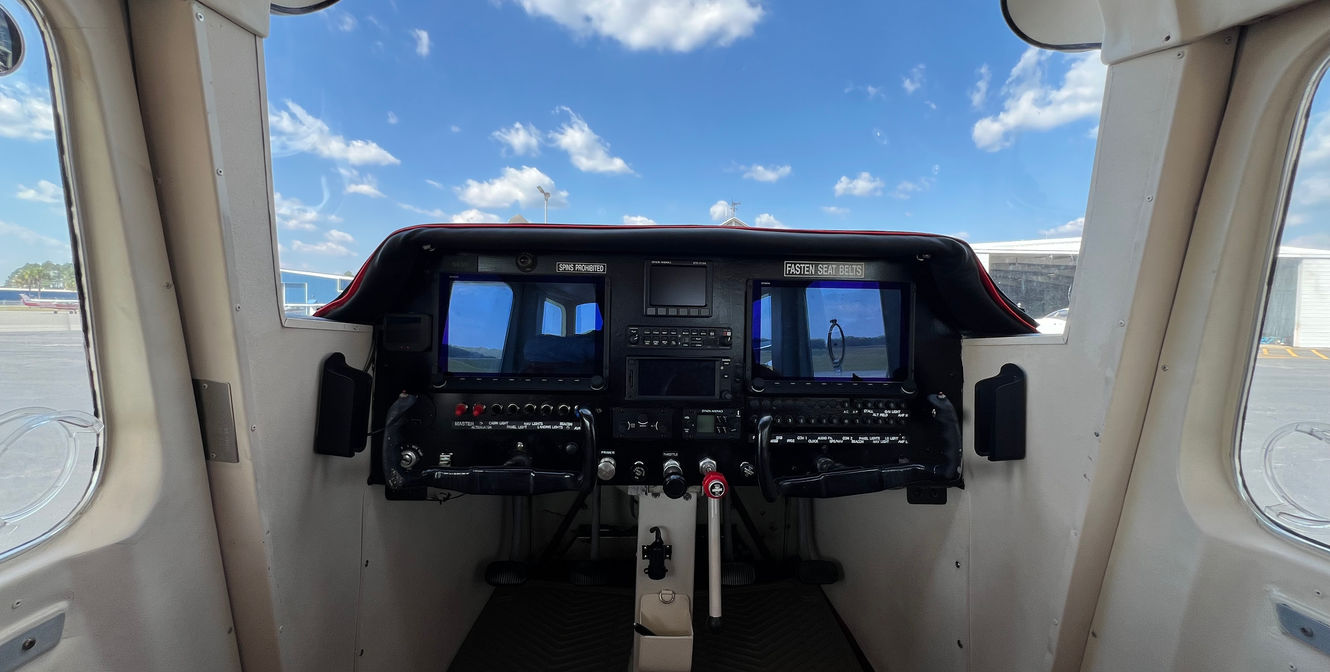 Airplane cockpit with a view of the sky and instrument panel.