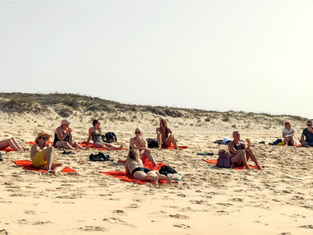 group relaxing on beach