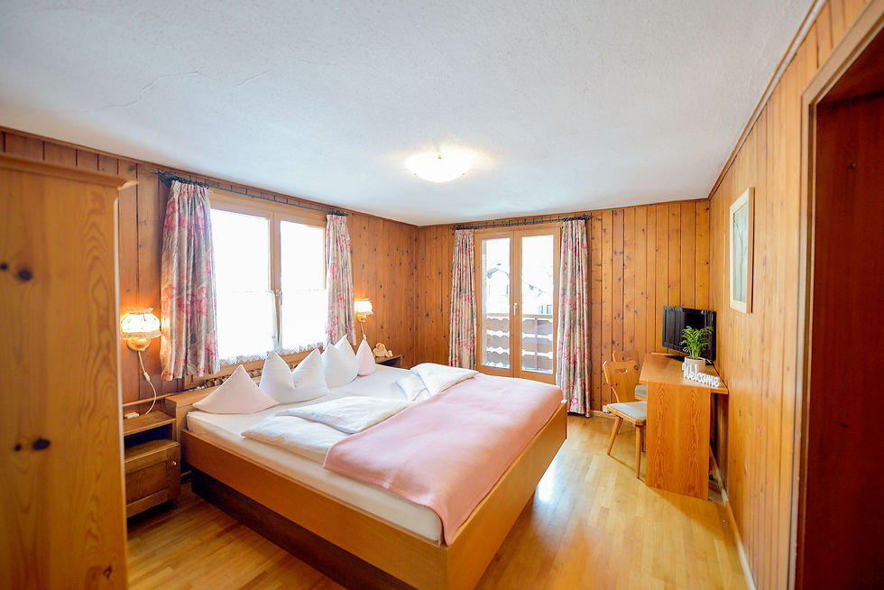 Inviting room 105 in Chalet Sonne, with tasteful wooden decor and a homely ambience.