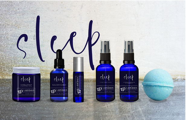 A row of different wellness products in blue cartons and jars, with navy blue labels