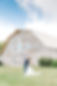 A couple kisses in front of the barn at The Silo Event Center, a western Kentucky wedding venue