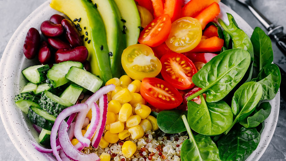 A vibrant and nutritious bowl featuring a colorful assortment of fresh vegetables, avocado slices, kidney beans, and quinoa, creating a wholesome and delicious meal.