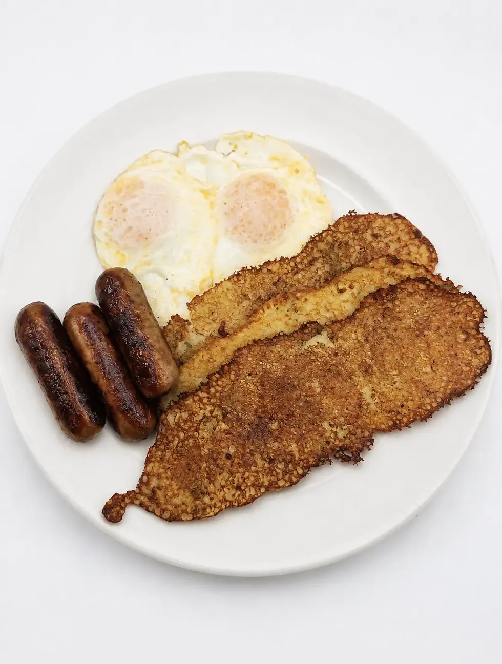 Three potato pancakes. two eggs (any style) served with three sausage links, applesauce and sour cream