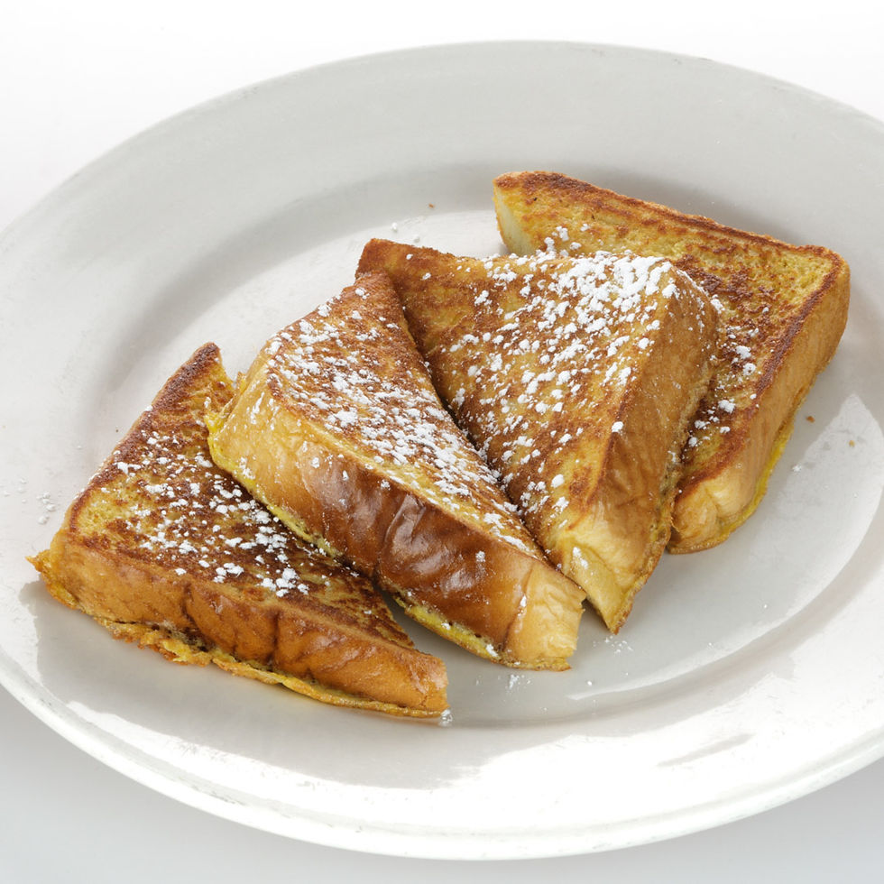 Two pieces of Texas toast served with butter and warm syrup.