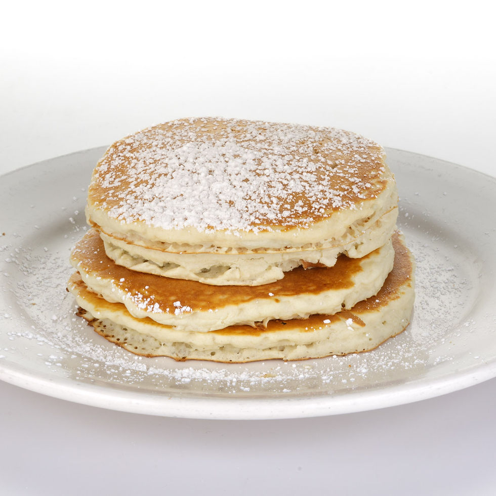 Fluffy buttermilk pancakes, golden-griddled and lightly sweet, served warm with butter and maple syrup.