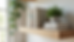 Close-up view of a natural oak solid wood floating shelf with books and plants