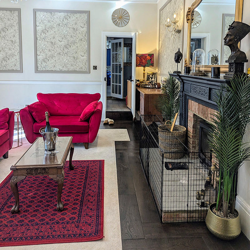 Elegant living room with red sofas and fireplace