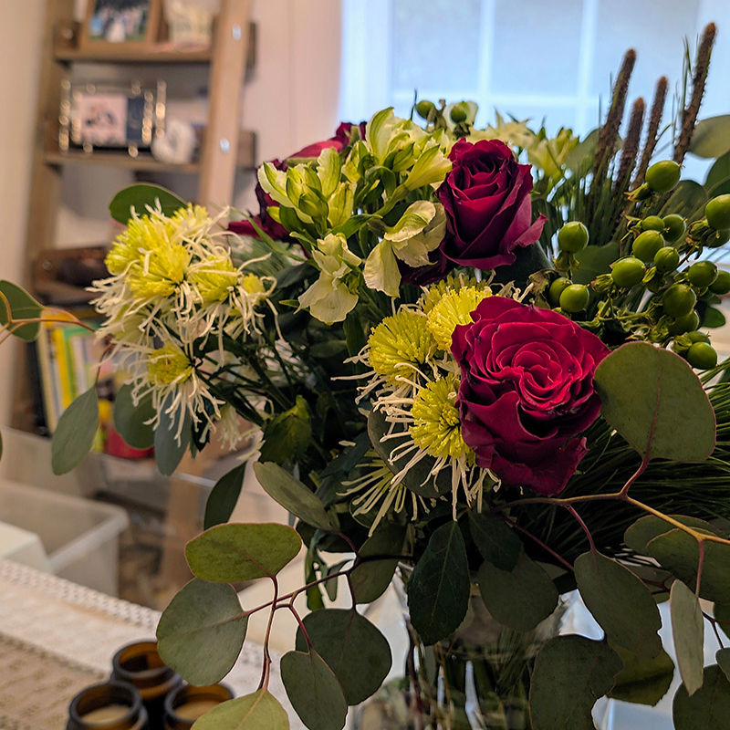 Red roses & yellow flowers in an interior