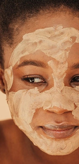 black_woman_applying_mud_mask-1296x728-h